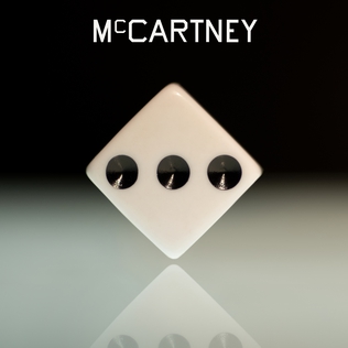 capa do album com um dado apontando para a face de numero três. fundo preto em gradiente